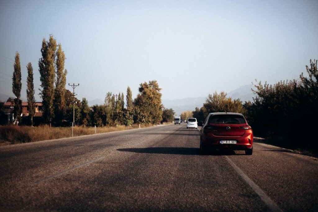 A car on a quiet tree-lined country road on the way to a walk